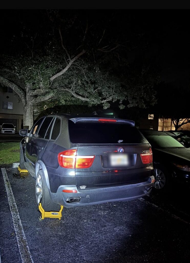 Booted BMW SUV at night