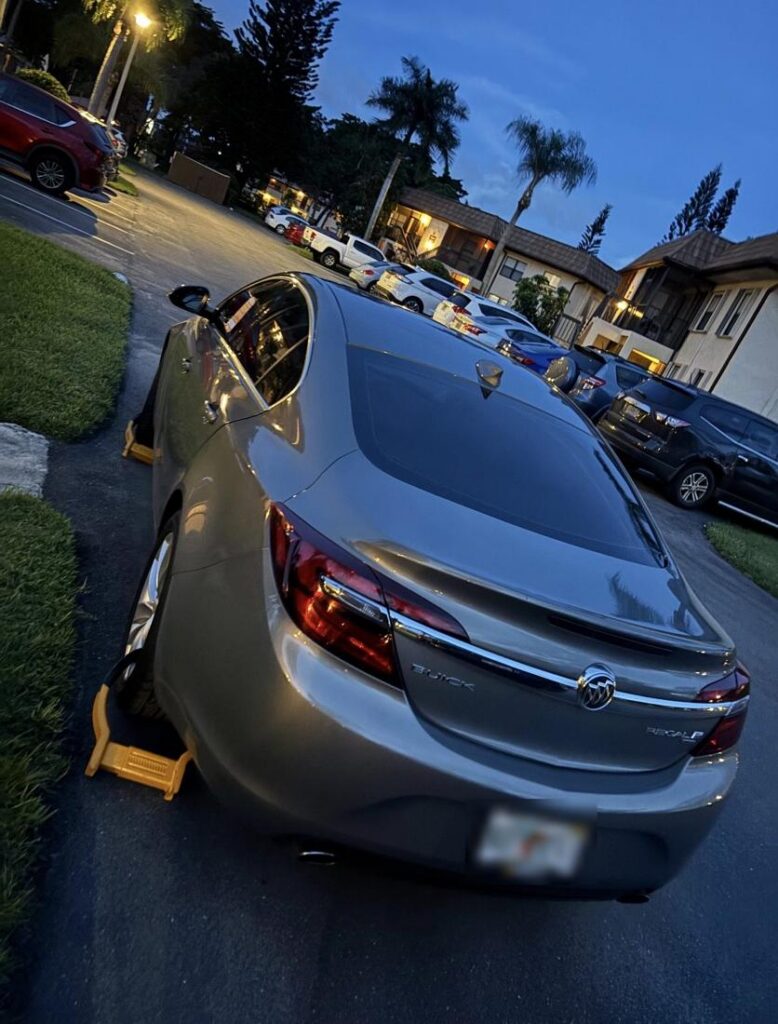 Booted Buick sedan at dusk