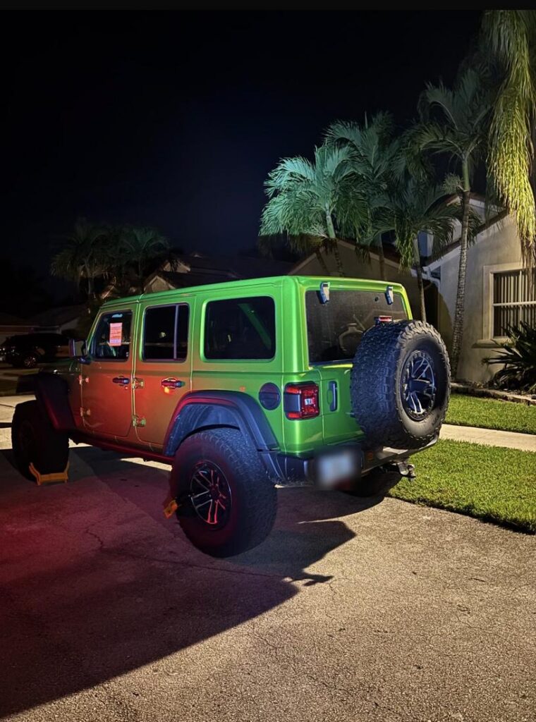 Booted Jeep Wrangler at night