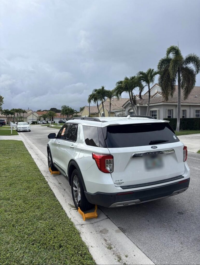 Booted Ford Explorer on a residential street